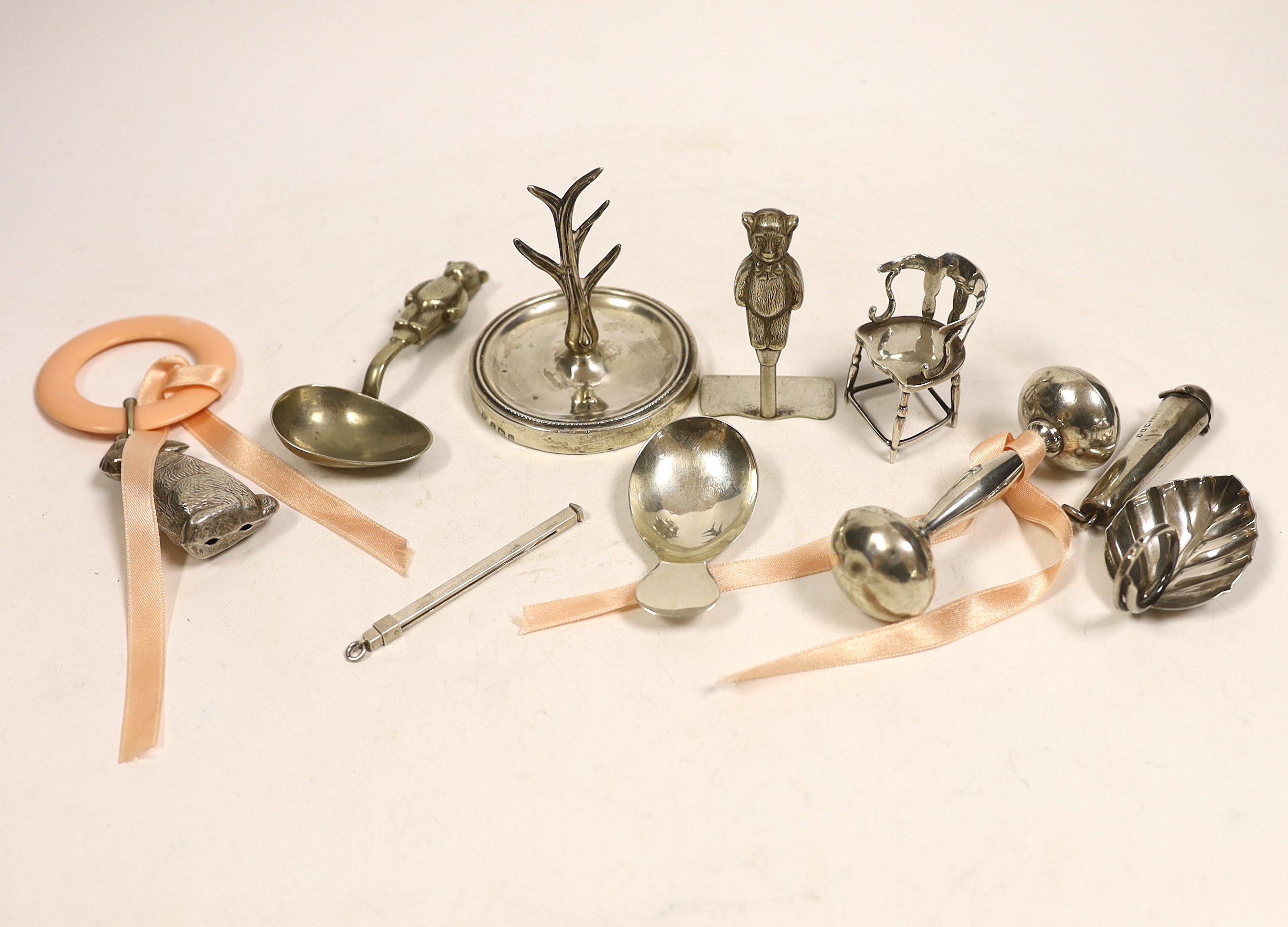 A collection of small silver including an Edwardian silver miniature model 'Dickens 1812-1870' chair, Levy & Salaman, Birmingham, 1910, 46mm, a Georgian silver caddy spoon, a Geoffrey G. Bellamy silver leaf caddy spoon,